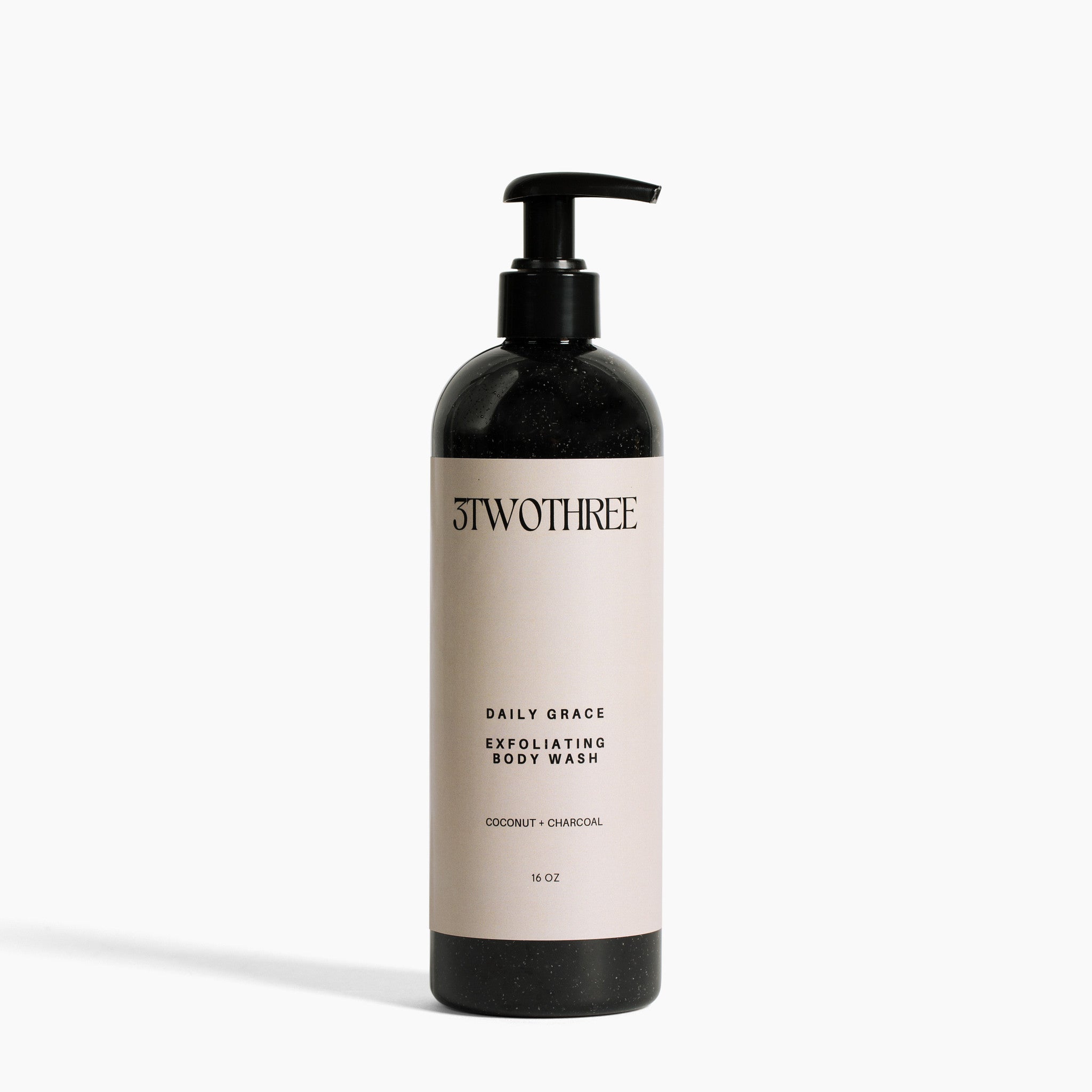 Daily Grace Exfoliating Body Wash in a minimalist plastic bottle with pump, photographed on neutral light grey background.